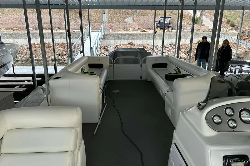 Slide: The Image of 2015 PlayCraft 25 Clipper pontoon boat interior with white seating and control panel. - 20