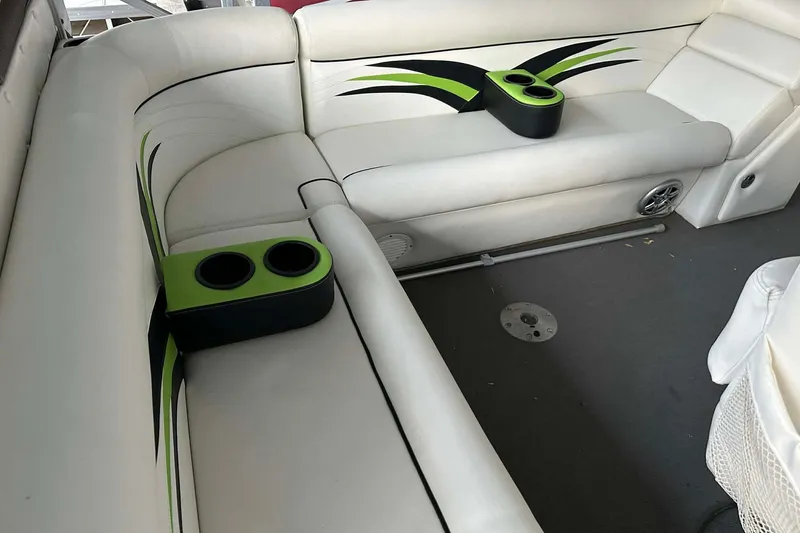 Slide: The Image of 2015 PlayCraft 25 Clipper boat interior with white seating and green accents. - 21