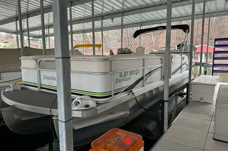 Slide: The Image of 2015 PlayCraft 25 Clipper pontoon boat docked under a covered marina. - 23