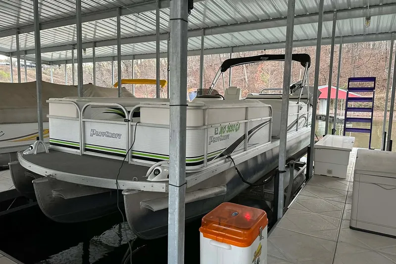 Slide: The Image of 2015 PlayCraft 25 Clipper pontoon boat docked in covered marina. - 24