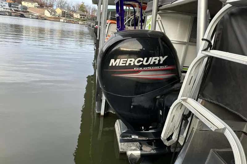 Slide: The Image of 2015 PlayCraft 25 Clipper with Mercury FourStroke engine docked by the water. - 3