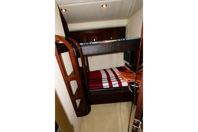 Slide: The Image of Bunk beds in 2007 Sea Ray 580 Sedan Bridge yacht cabin, featuring cozy interior design. - 17