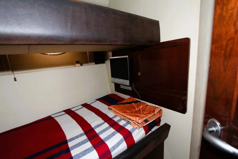 Slide: The Image of Cozy cabin interior of 2007 Sea Ray 580 Sedan Bridge with bunk bed and TV. - 18