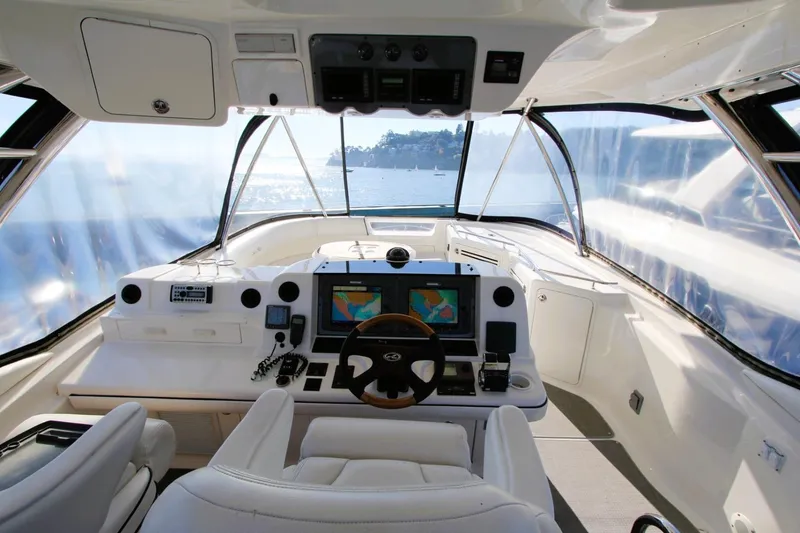 Slide: The Image of 2007 Sea Ray 580 Sedan Bridge helm with navigation screens and ocean view. - 28