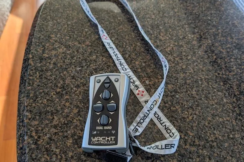 Slide: The Image of Remote control for 2007 Sea Ray 580 Sedan Bridge yacht on granite surface. - 32