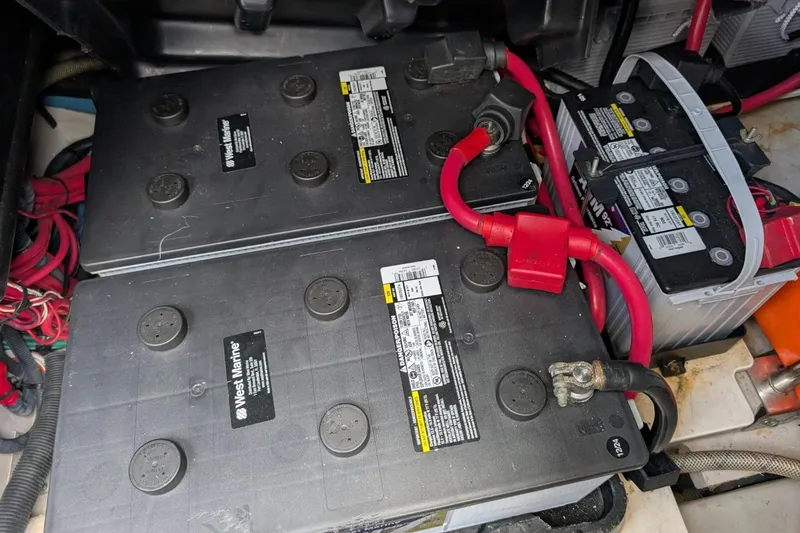 Slide: The Image of Batteries in a 2007 Sea Ray 580 Sedan Bridge engine compartment with red cables. - 36