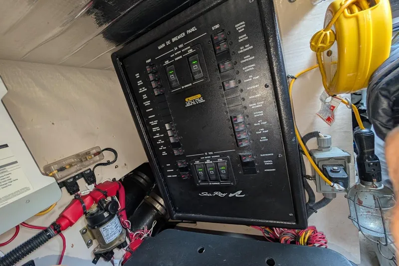Slide: The Image of Electrical panel of 2007 Sea Ray 580 Sedan Bridge yacht, featuring various switches and wiring. - 38