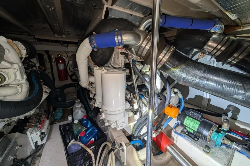 Slide: The Image of Engine room of a 2007 Sea Ray 580 Sedan Bridge with visible machinery and components. - 39