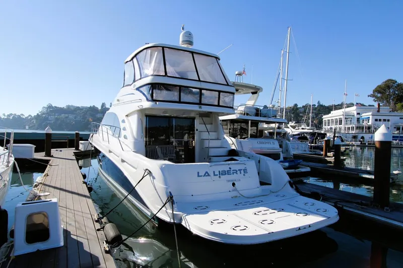 Slide: The Image of 2007 Sea Ray 580 Sedan Bridge yacht docked at marina, sunny day. - 4
