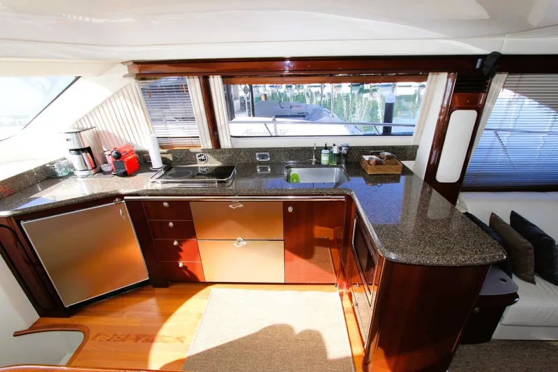 Slide: The Image of Luxurious kitchen interior of 2007 Sea Ray 580 Sedan Bridge yacht with modern amenities. - 6