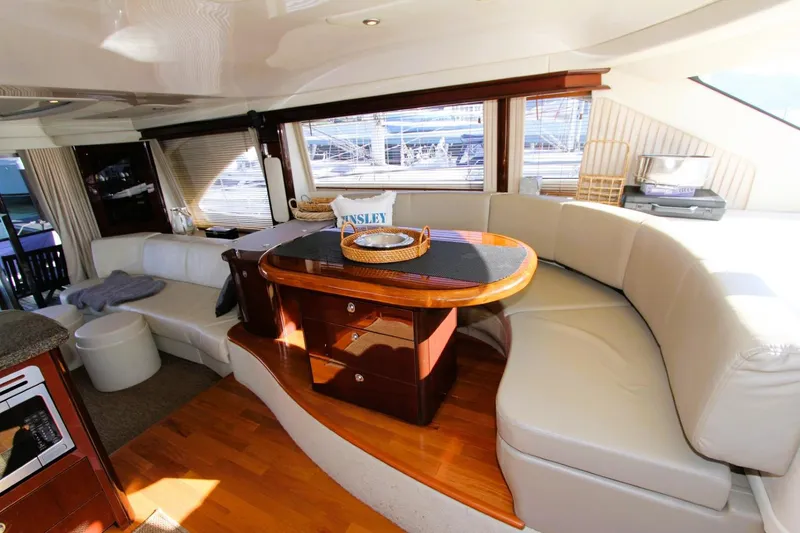 Slide: The Image of Luxurious interior of 2007 Sea Ray 580 Sedan Bridge yacht with elegant seating and table. - 7