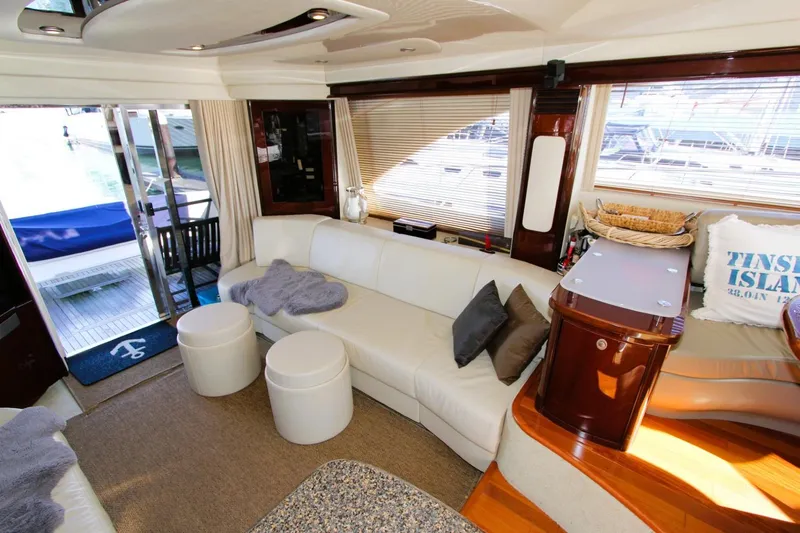 Slide: The Image of Luxurious interior of 2007 Sea Ray 580 Sedan Bridge yacht with white seating and elegant decor. - 9
