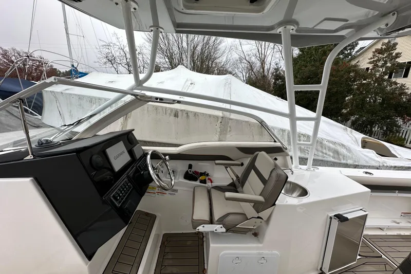 Slide: The Image of 2022 Cutwater C-24 DC boat interior with steering wheel and seating. - 10