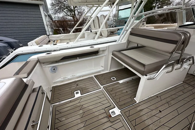 Slide: The Image of 2022 Cutwater C-24 DC boat interior with cushioned seating and teak flooring. - 11