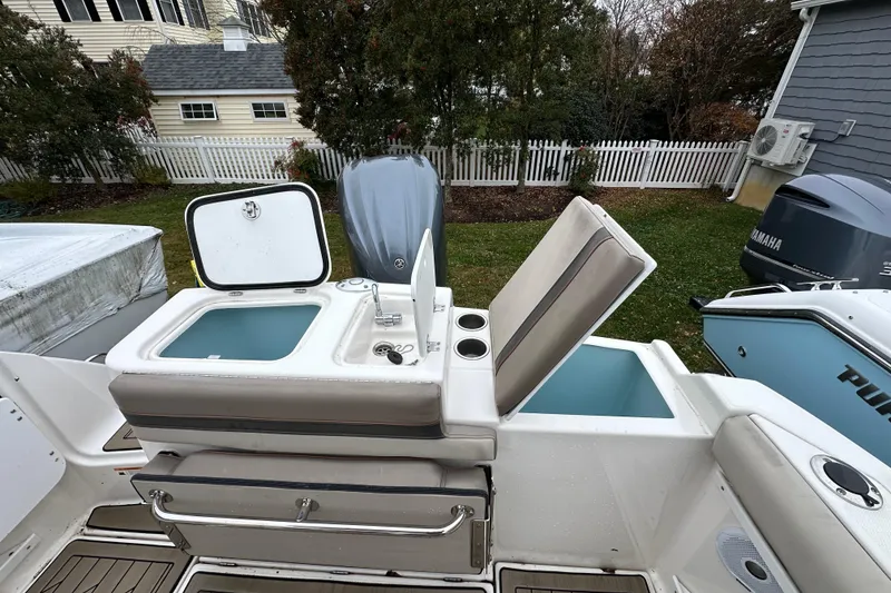 Slide: The Image of 2022 Cutwater C-24 DC boat with open storage compartments and Yamaha engine. - 13