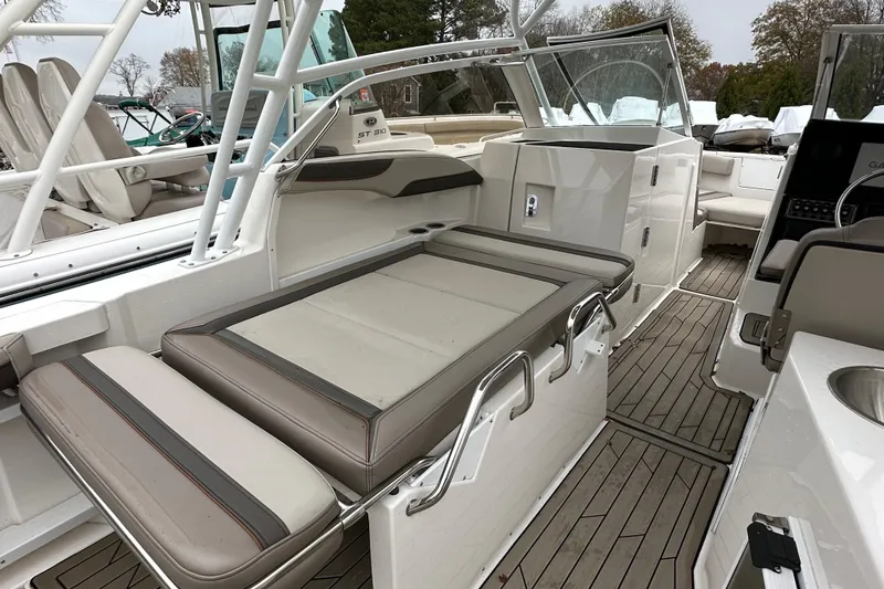 Slide: The Image of 2022 Cutwater C-24 DC boat interior with seating and teak flooring. - 14