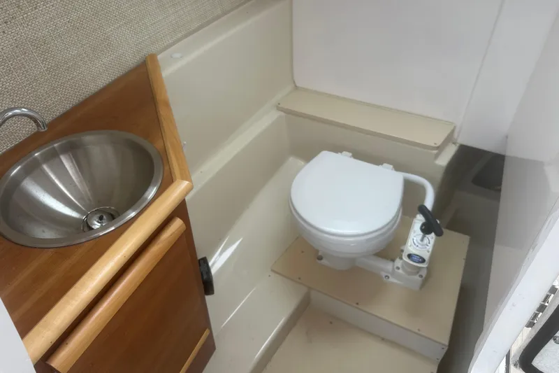 Slide: The Image of 2022 Cutwater C-24 DC boat bathroom with sink and toilet. - 15