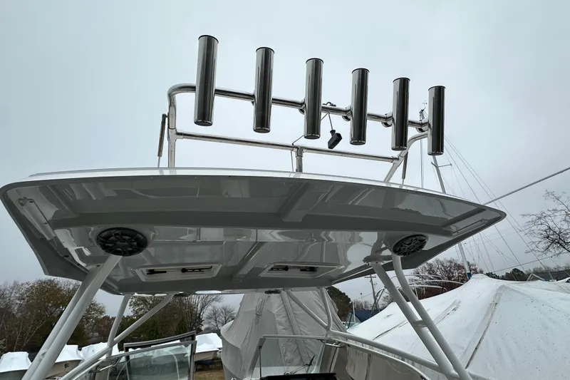 Slide: The Image of 2022 Cutwater C-24 DC boat with rod holders and speakers on the roof. - 16