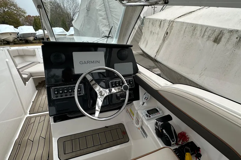 Slide: The Image of 2022 Cutwater C-24 DC boat helm with Garmin navigation system and modern controls. - 5