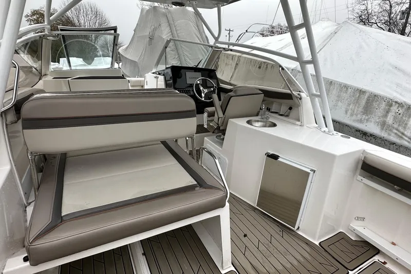 Slide: The Image of 2022 Cutwater C-24 DC boat interior with seating, steering wheel, and sink. - 7