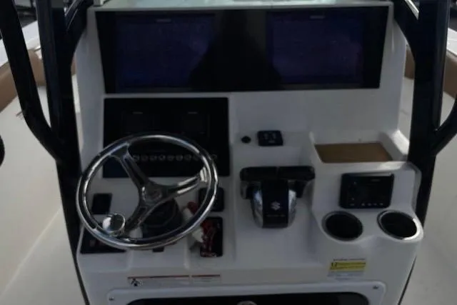 Slide: The Image of 2023 Sea Pro 259 Deep V CC boat console with steering wheel and dual displays. - 8