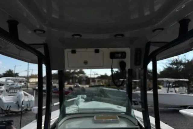 Slide: The Image of 2023 Sea Pro 259 Deep V CC boat interior with console and overhead storage. - 9