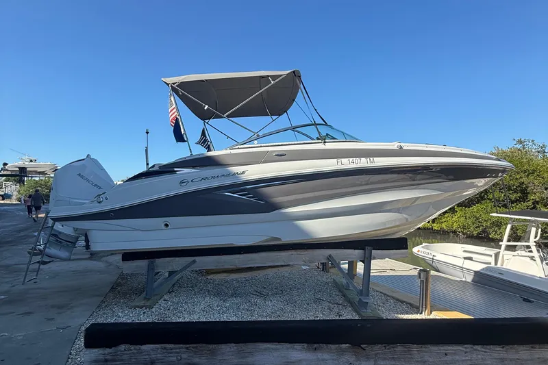 Slide: The Image of 2022 Crownline Eclipse E235 XS boat on display with canopy and Mercury engine. - 1