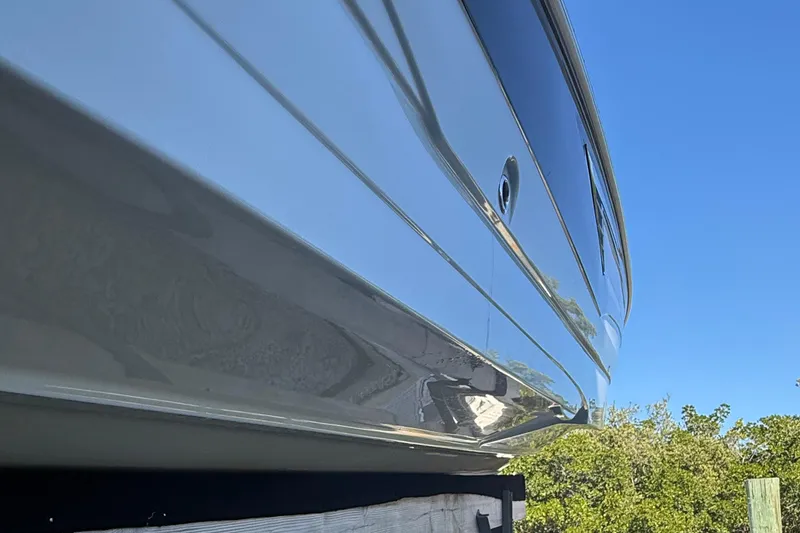 Slide: The Image of 2022 Crownline Eclipse E235 XS boat hull against clear blue sky. - 16