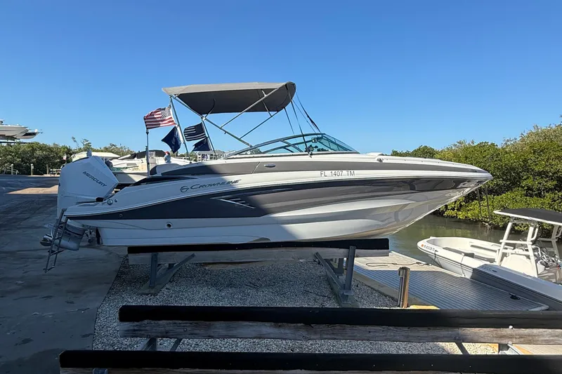 Slide: The Image of 2022 Crownline Eclipse E235 XS boat on a dock, with a Mercury engine. - 22