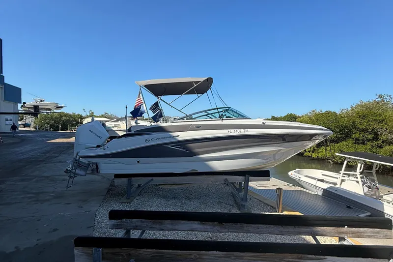Slide: The Image of 2022 Crownline Eclipse E235 XS boat on a dock under clear blue sky. - 25