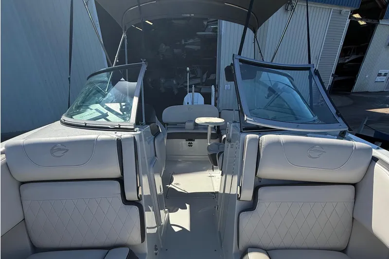 Slide: The Image of 2022 Crownline Eclipse E235 XS boat interior with seating and windshield. - 26