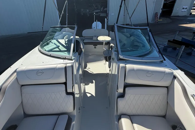 Slide: The Image of 2022 Crownline Eclipse E235 XS boat interior with white seating and open cockpit. - 30
