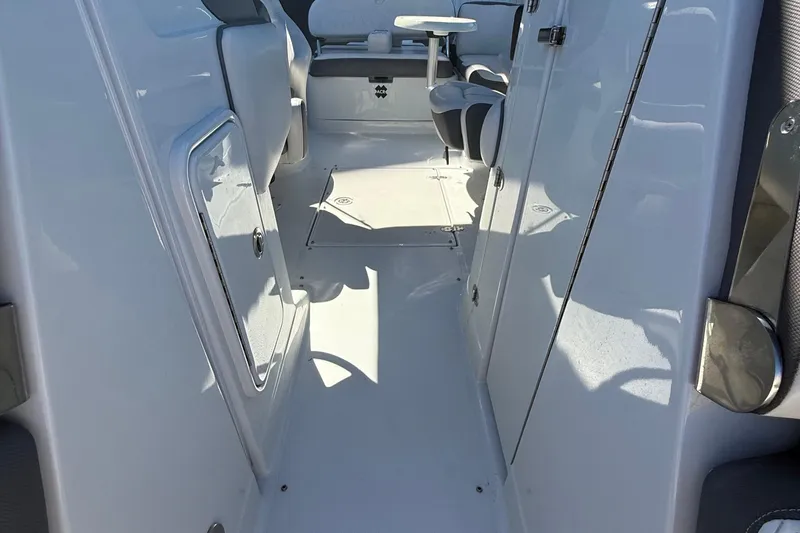 Slide: The Image of 2022 Crownline Eclipse E235 XS boat interior with seating and storage compartments. - 38