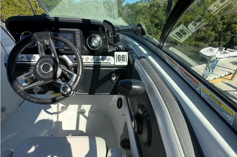 Slide: The Image of 2022 Crownline Eclipse E235 XS boat dashboard with steering wheel and controls. - 40
