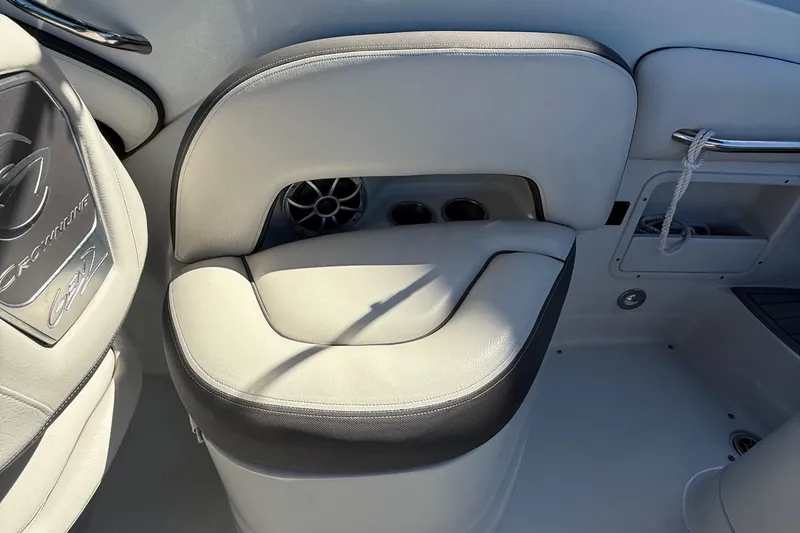Slide: The Image of 2022 Crownline Eclipse E235 XS boat interior with cushioned seating and speaker. - 41