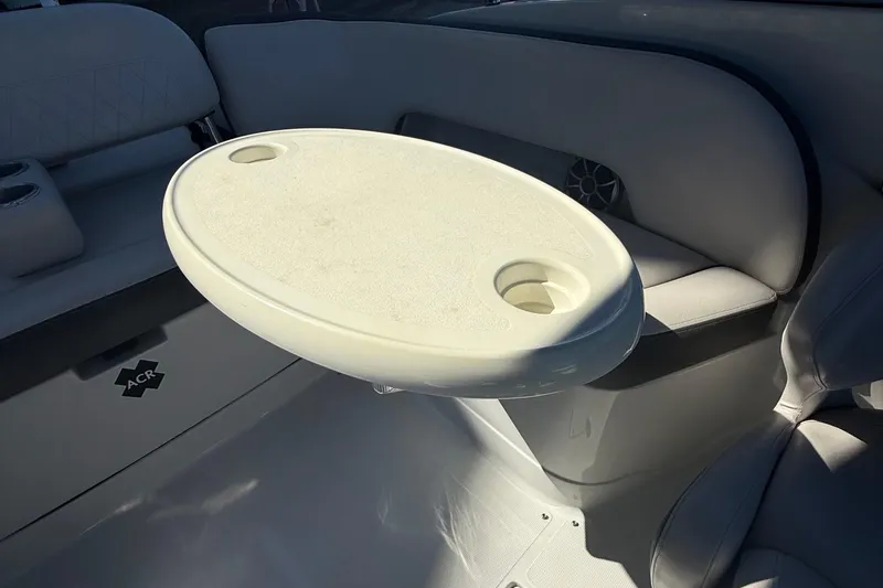 Slide: The Image of 2022 Crownline Eclipse E235 XS boat interior with oval table and seating. - 43