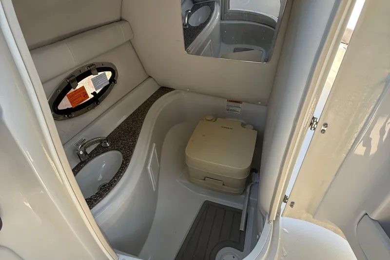 Slide: The Image of 2022 Crownline Eclipse E235 XS boat bathroom with sink and portable toilet. - 47