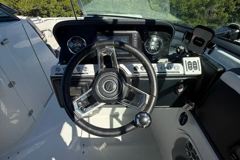 Slide: The Image of 2022 Crownline Eclipse E235 XS boat dashboard with steering wheel and control panel. - 48