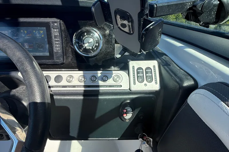 Slide: The Image of Dashboard of 2022 Crownline Eclipse E235 XS boat with controls and steering wheel. - 53