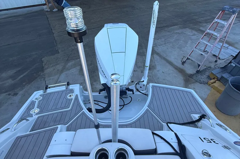 Slide: The Image of 2022 Crownline Eclipse E235 XS boat stern with motor and deck details. - 55