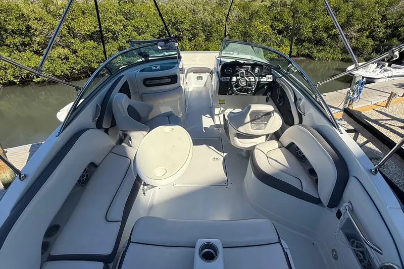 Slide: The Image of 2022 Crownline Eclipse E235 XS boat interior with seating and steering wheel. - 57