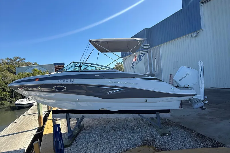 Slide: The Image of 2022 Crownline Eclipse E235 XS boat on display at a marina. - 8