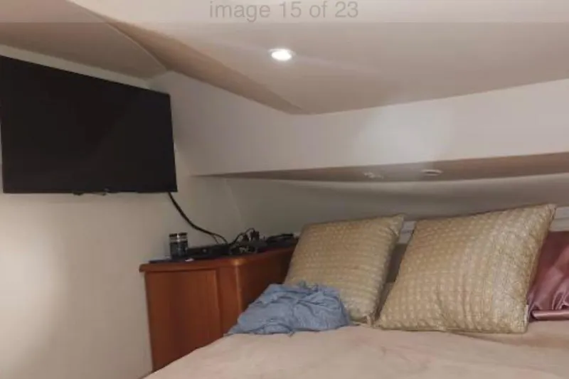 Slide: The Image of Cozy cabin interior of 2001 Silverton 330 Sport Bridge with TV and pillows. - 2