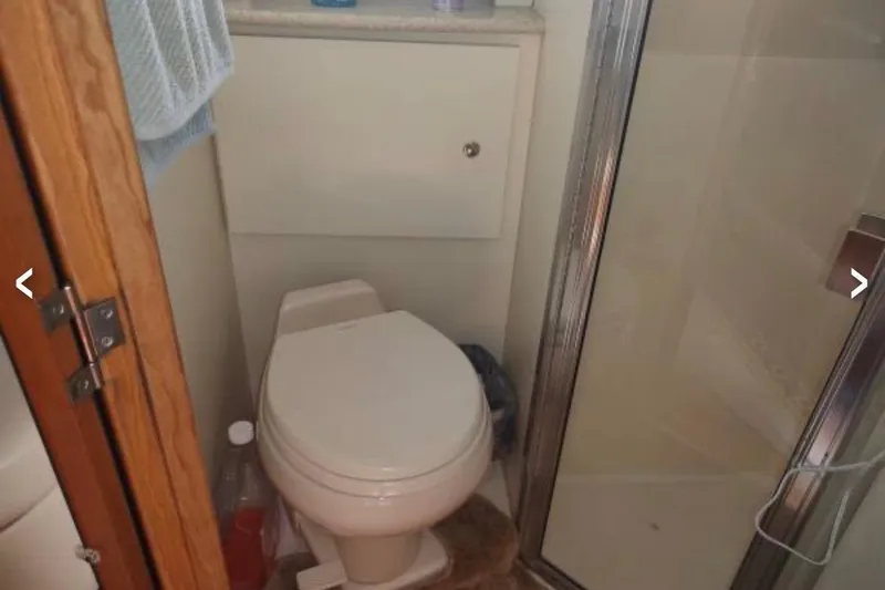Slide: The Image of Bathroom in 2001 Silverton 330 Sport Bridge yacht with shower and toilet. - 9