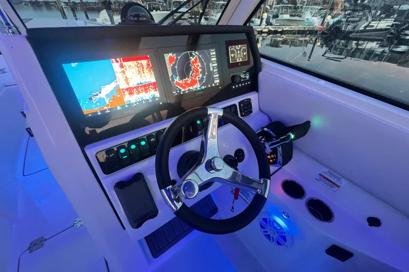 Slide: The Image of 2025 Sailfish 276 DC boat dashboard with advanced navigation displays and controls. - 7