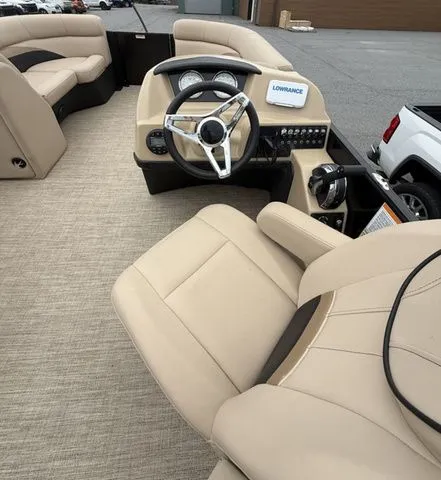 Slide: The Image of 2020 Barletta Boats C20Q interior with beige seating and modern dashboard. - 9