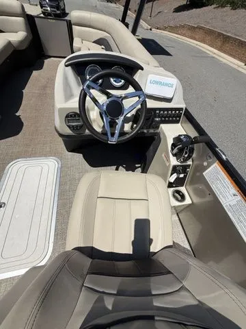 Slide: The Image of 2021 Barletta Boats C24Q helm with steering wheel and Lowrance navigation system. - 11