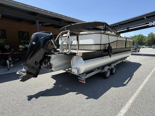 Slide: The Image of 2021 Barletta Boats C24Q pontoon on trailer, parked outdoors under clear sky. - 3