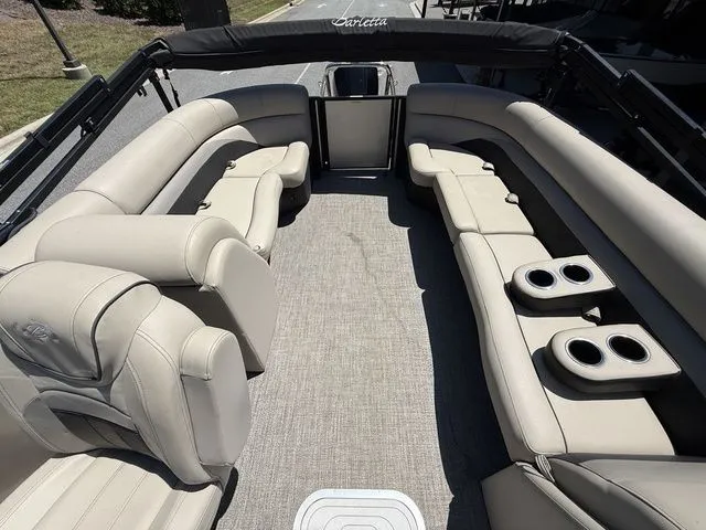 Slide: The Image of 2021 Barletta Boats C24Q interior with plush seating and cup holders. - 7