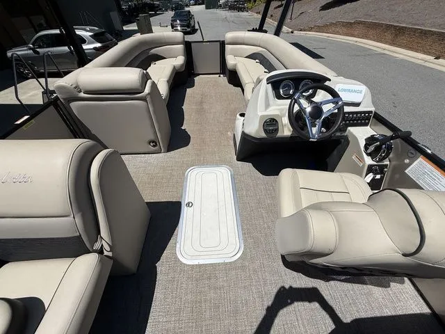 Slide: The Image of 2021 Barletta Boats C24Q interior with plush seating and modern dashboard. - 10
